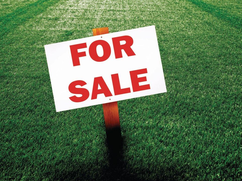 A printed For Sale sign out working on a lawn